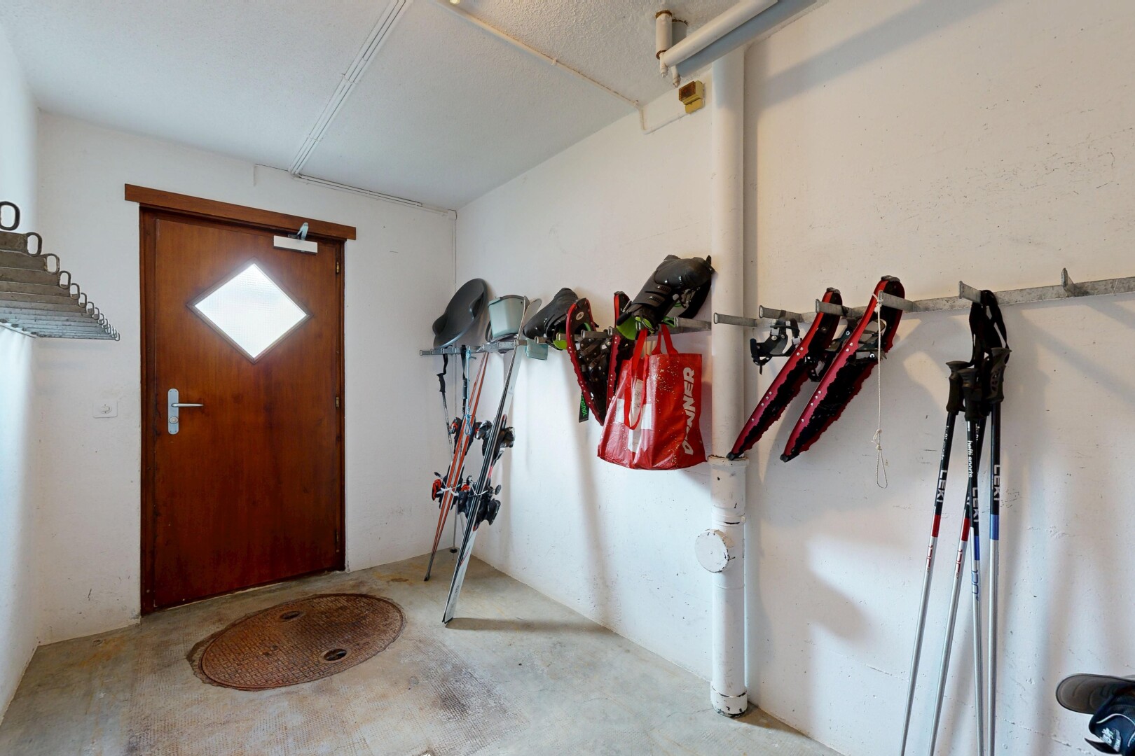 hallway with unfinished concrete flooring