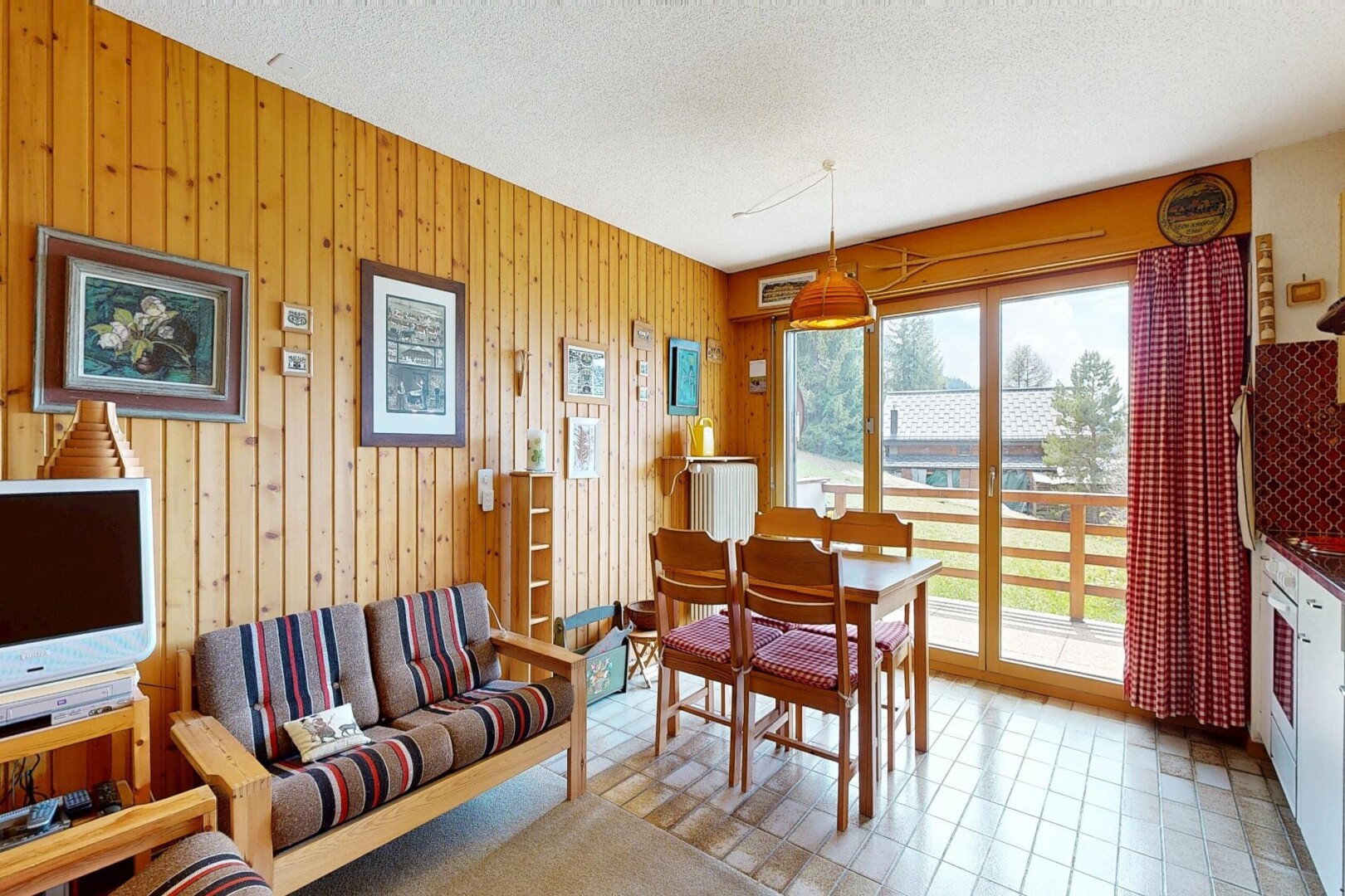 living area with a textured ceiling and wooden walls