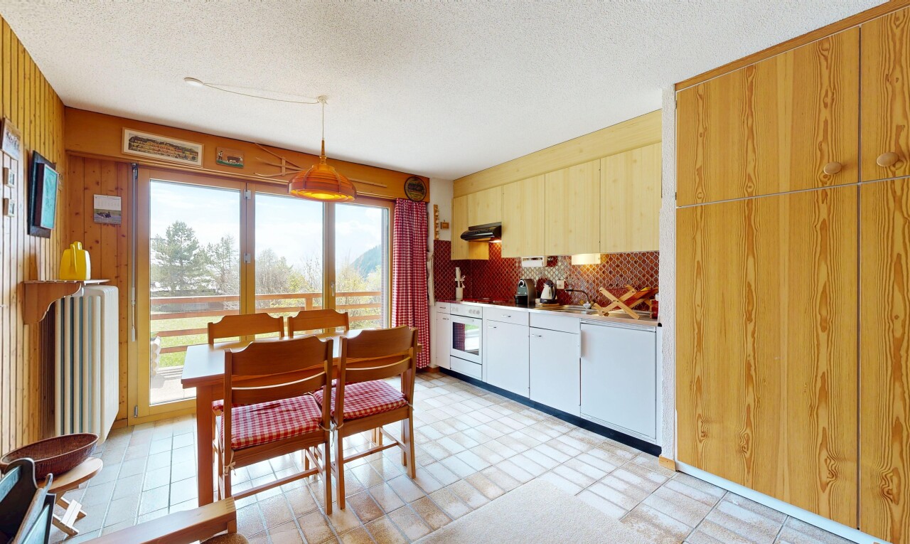 dining area featuring a textured ceiling and light flooring