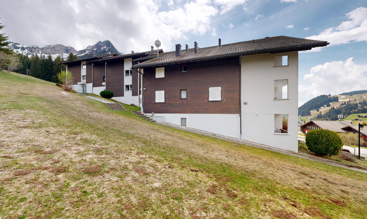 outdoor house with a mountain view and a lawn