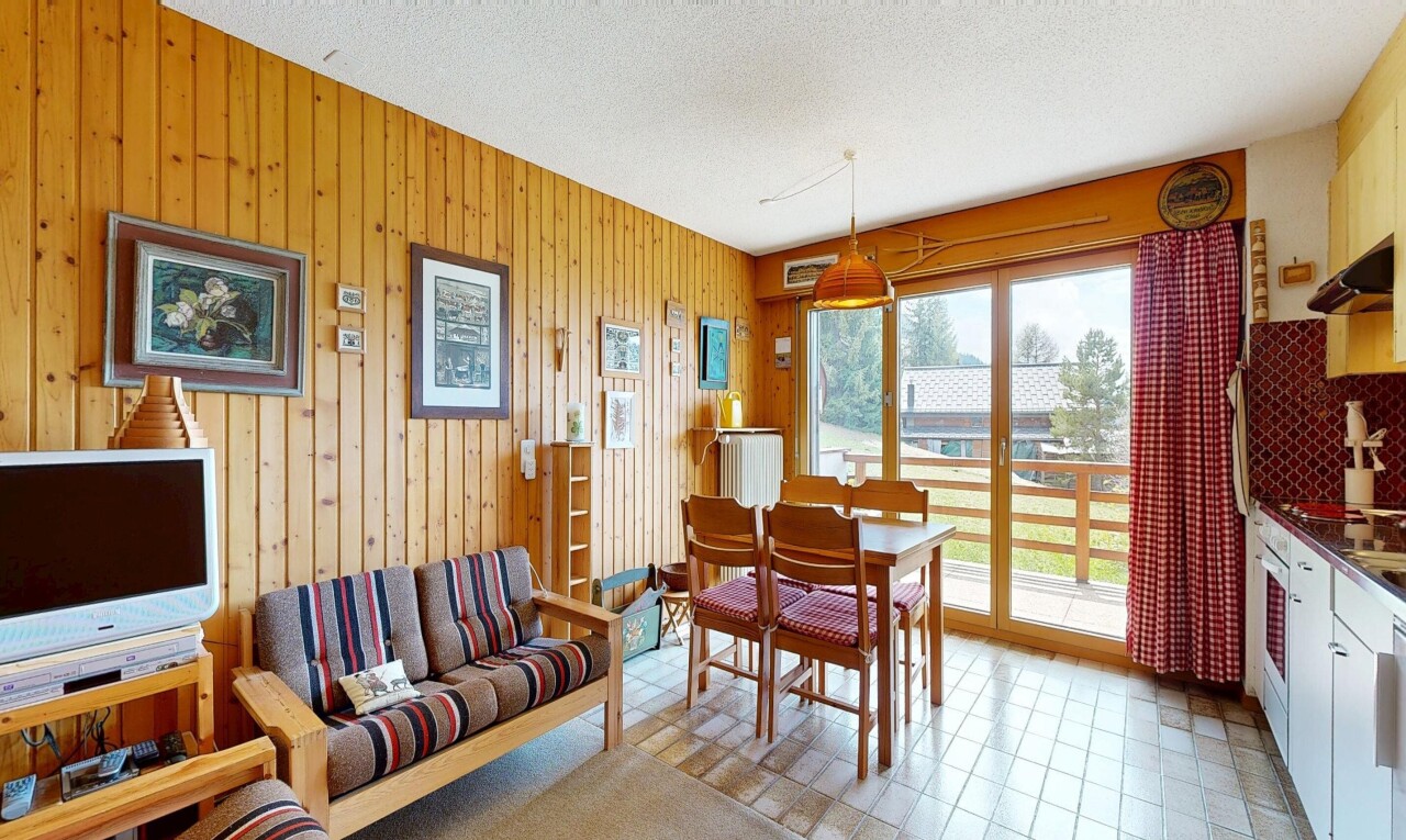 living area with a textured ceiling and wooden walls