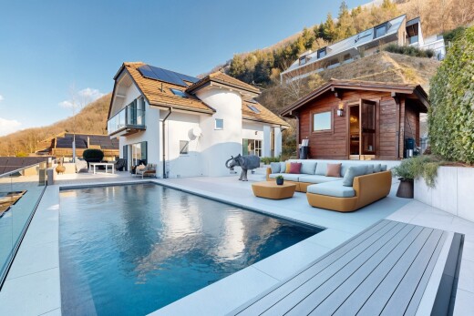 outdoor pool with an outdoor living space, an outdoor structure, and a patio area