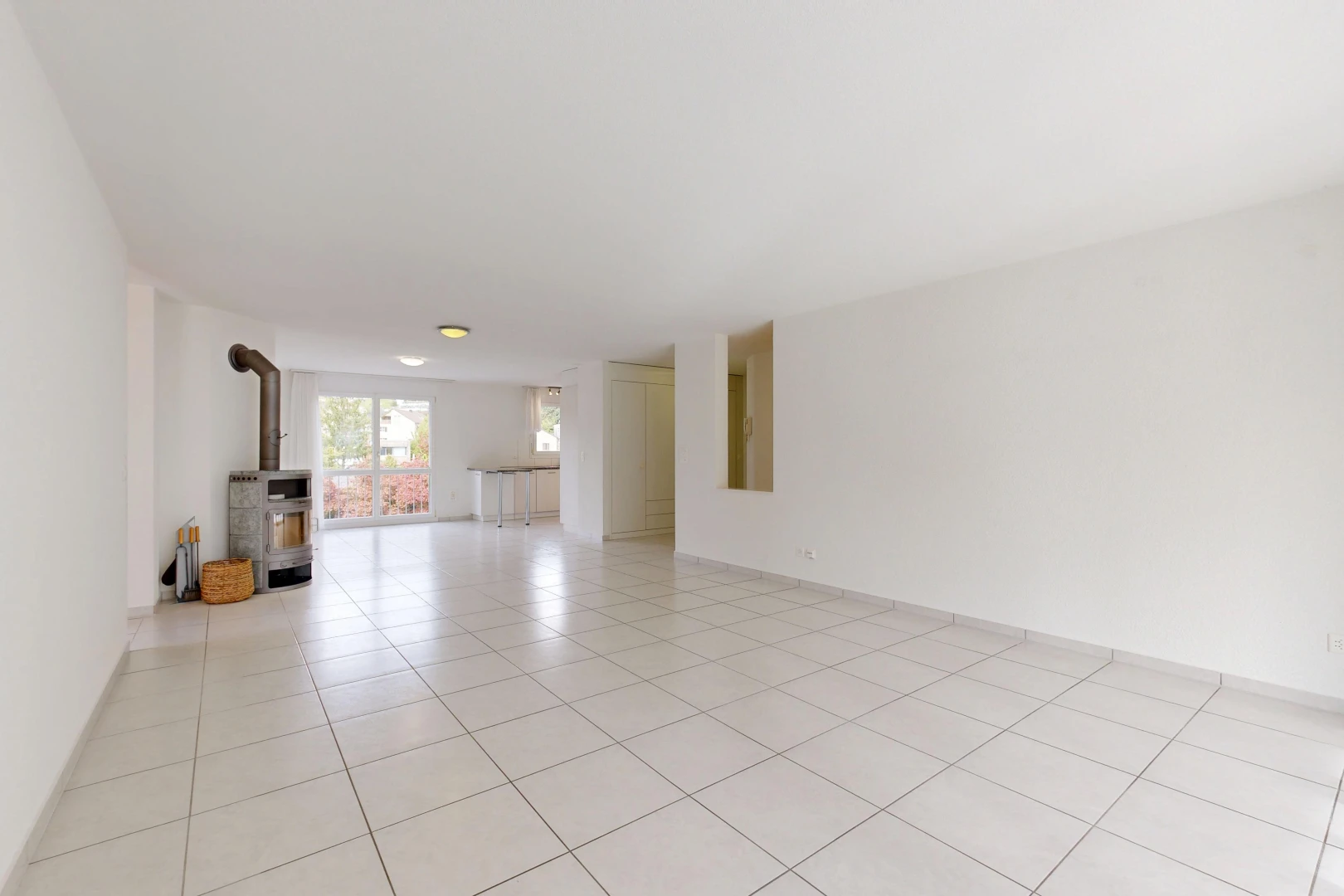 pièce vide avec poêle à bois, cloison sèche, drywall, light floor, et inside property