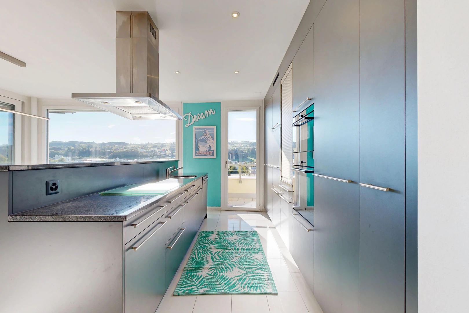küche mit dunstabzugshaube, light floor, dark countertops, flat panel cabinets, und schränke mit flachen paneelen