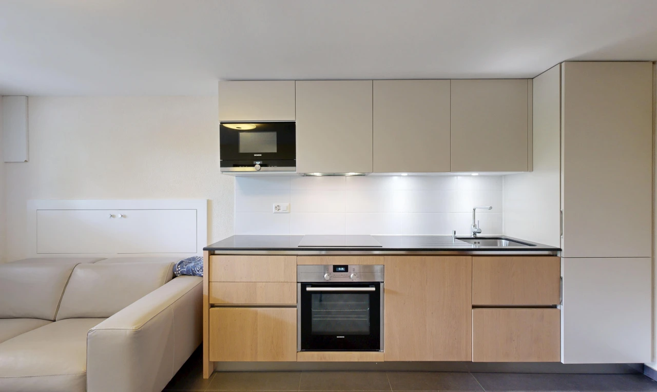 cuisine avec two tone kitchen, four, micro-ondes, évier, et flat panel cabinets