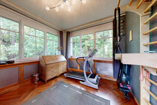 workout area with radiator heating unit and parquet flooring