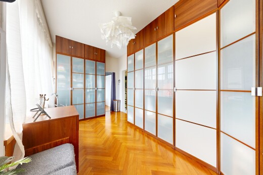 room / bedroom featuring parquet floors and a chandelier