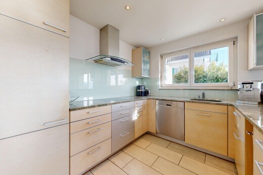 kitchen featuring glass insert cabinets, wall chimney exhaust hood, light stone counters, stainless steel dishwasher, and recessed lighting