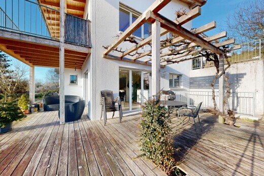 view of wooden terrace featuring a balcony, outdoor dining area, and a pergola