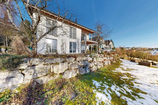view of home featuring a balcony and stucco siding