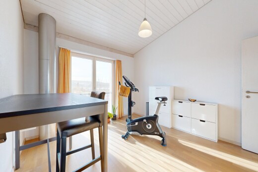 gym featuring vaulted ceiling and light wood-style flooring