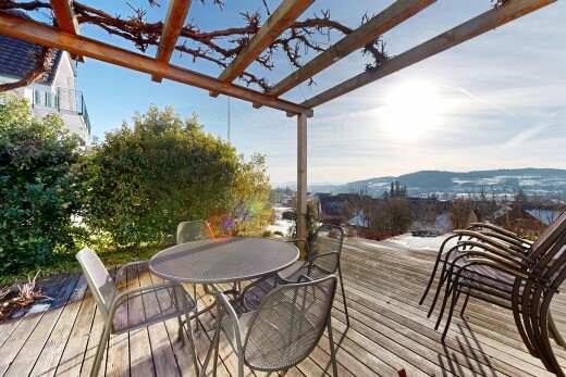 view of wooden terrace featuring outdoor dining area and a pergola