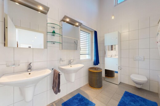 bathroom with tile patterned flooring, tile walls, a shower, and decorative backsplash