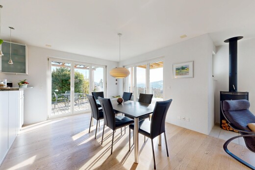 dining area featuring a wood stove and light wood finished floors