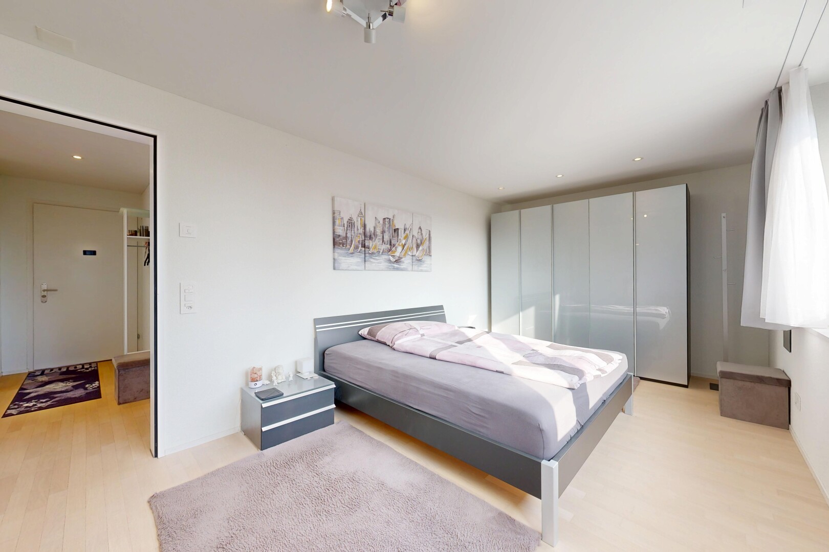 room with light wood finished floors and recessed lighting