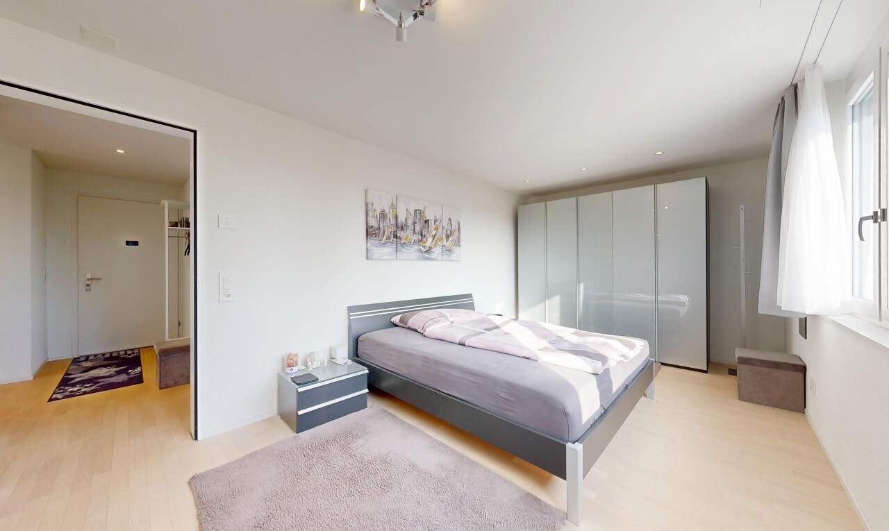 room with light wood finished floors and recessed lighting