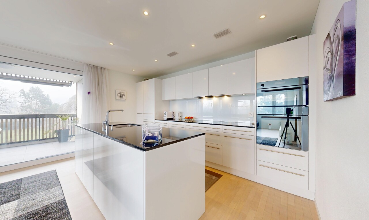 kitchen with white cabinets, modern cabinets, double wall oven, a center island with sink, and recessed lighting