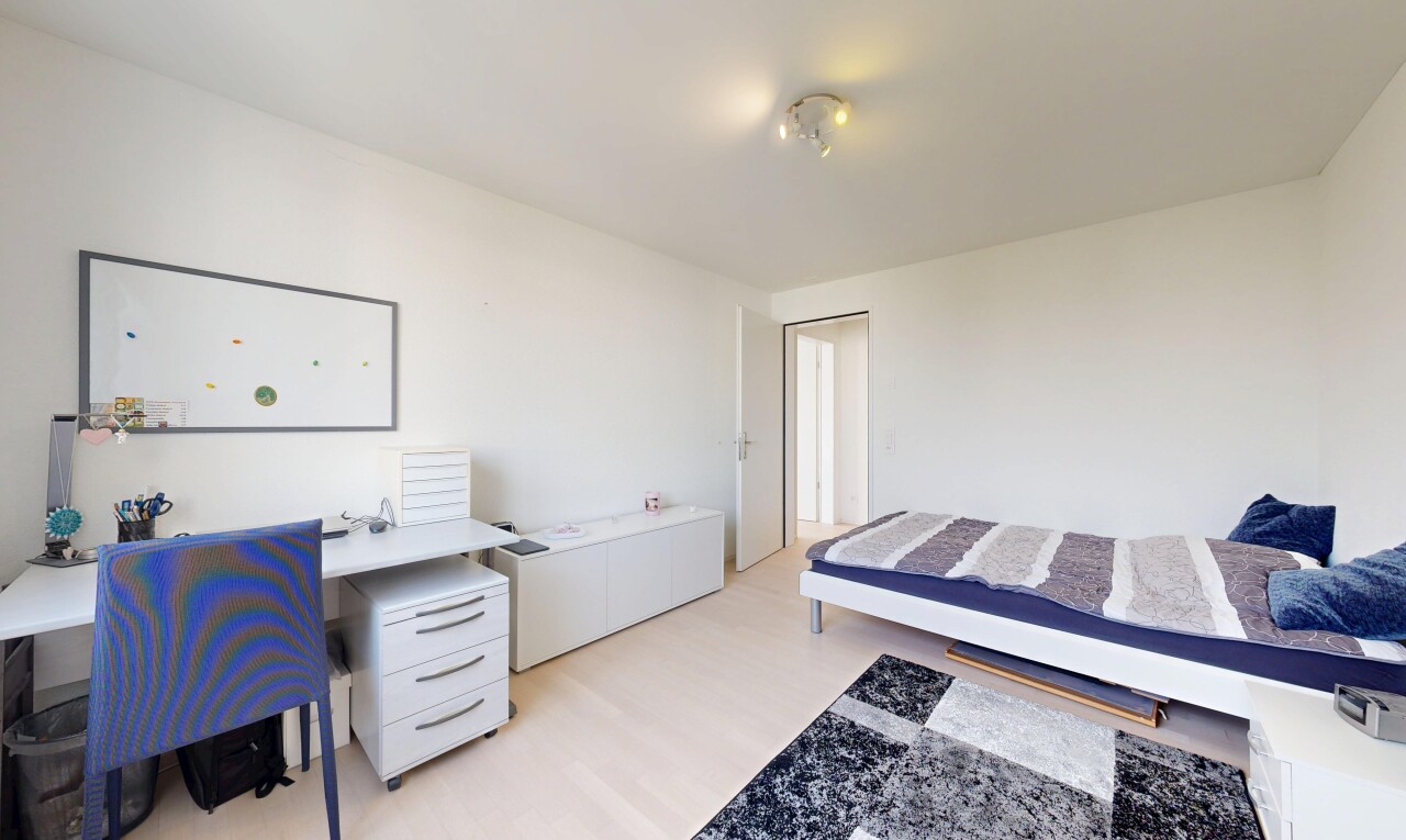 room featuring light wood-style floors and an office area