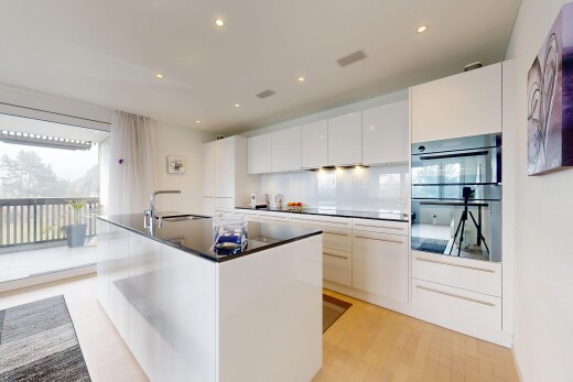 kitchen with white cabinets, modern cabinets, double wall oven, a center island with sink, and recessed lighting