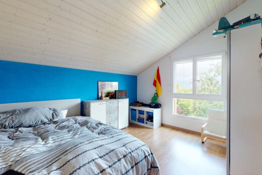 chambre avec vaulted ceiling, plafond voûté, drywall, cloison sèche, et wood finish floor