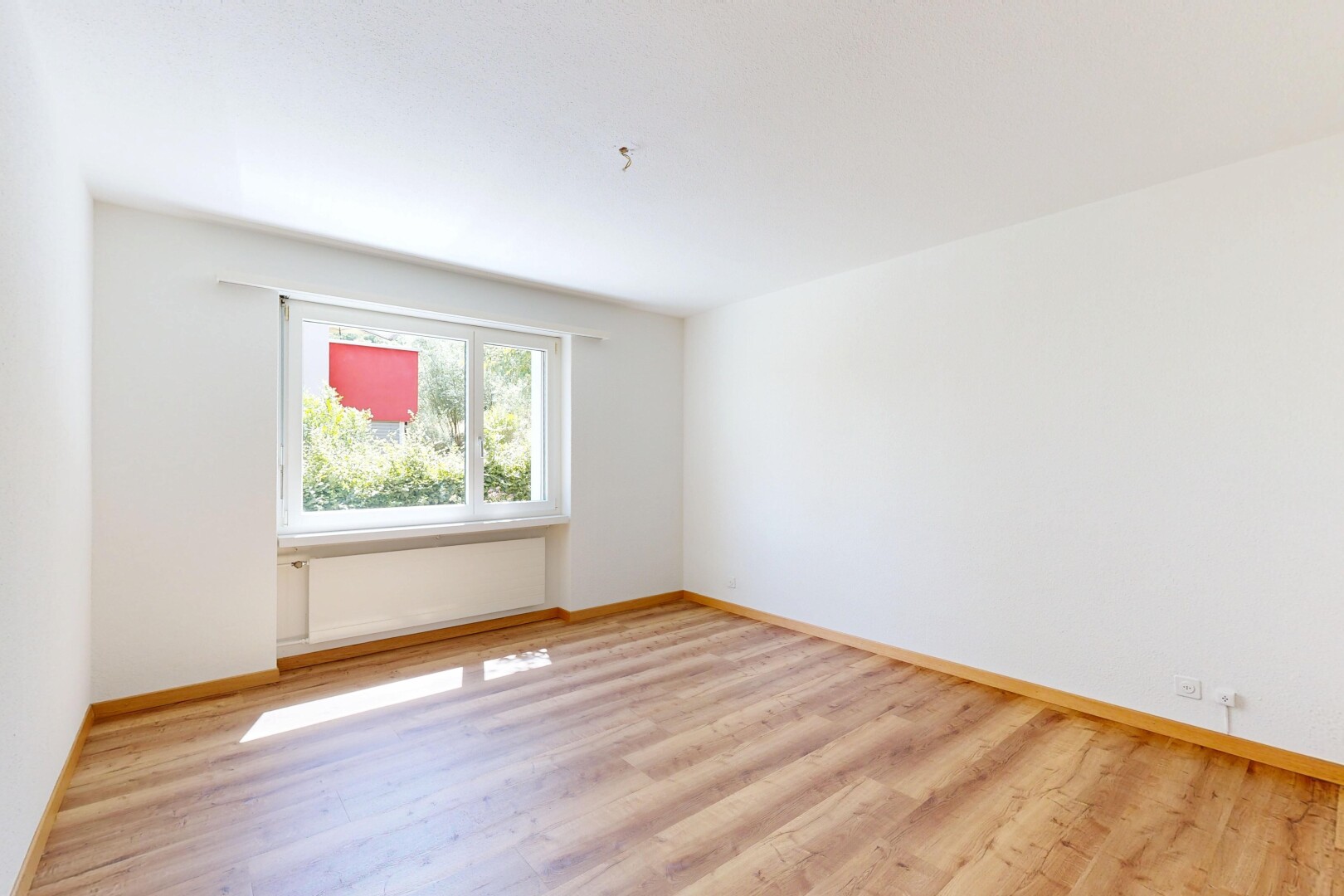 empty room featuring light wood-style floors and baseboards