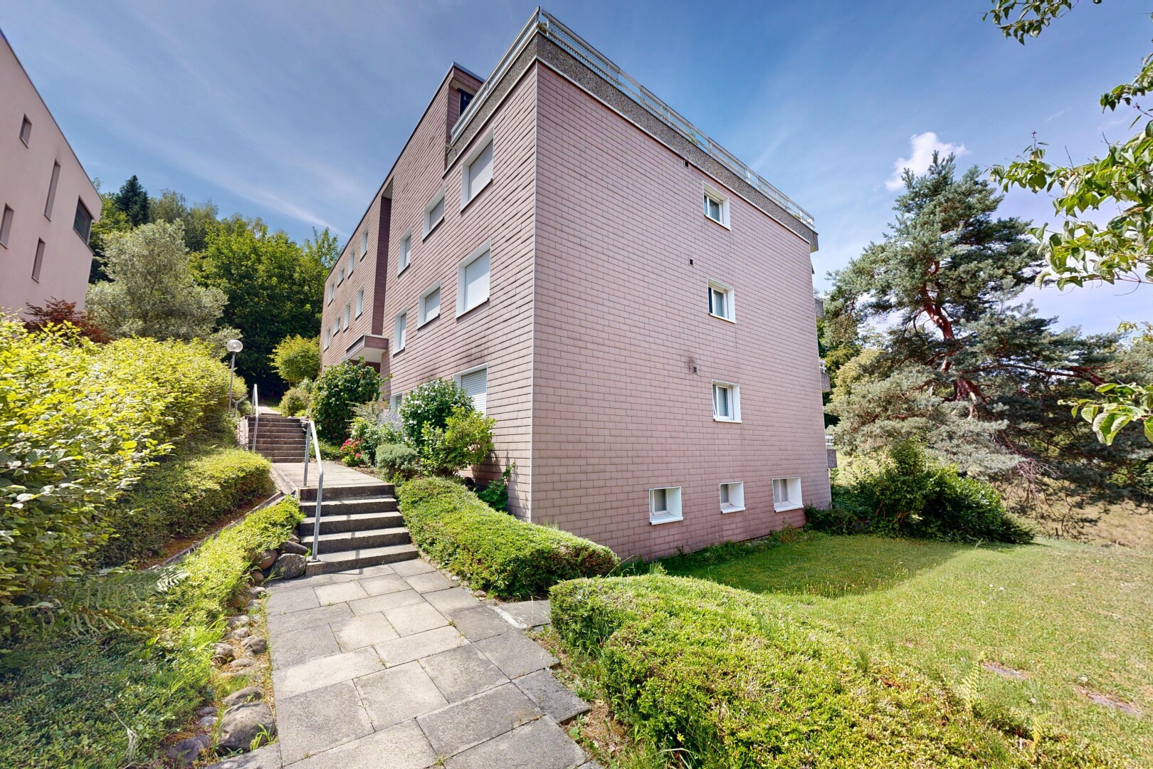 view of apartment building / complex featuring stairway