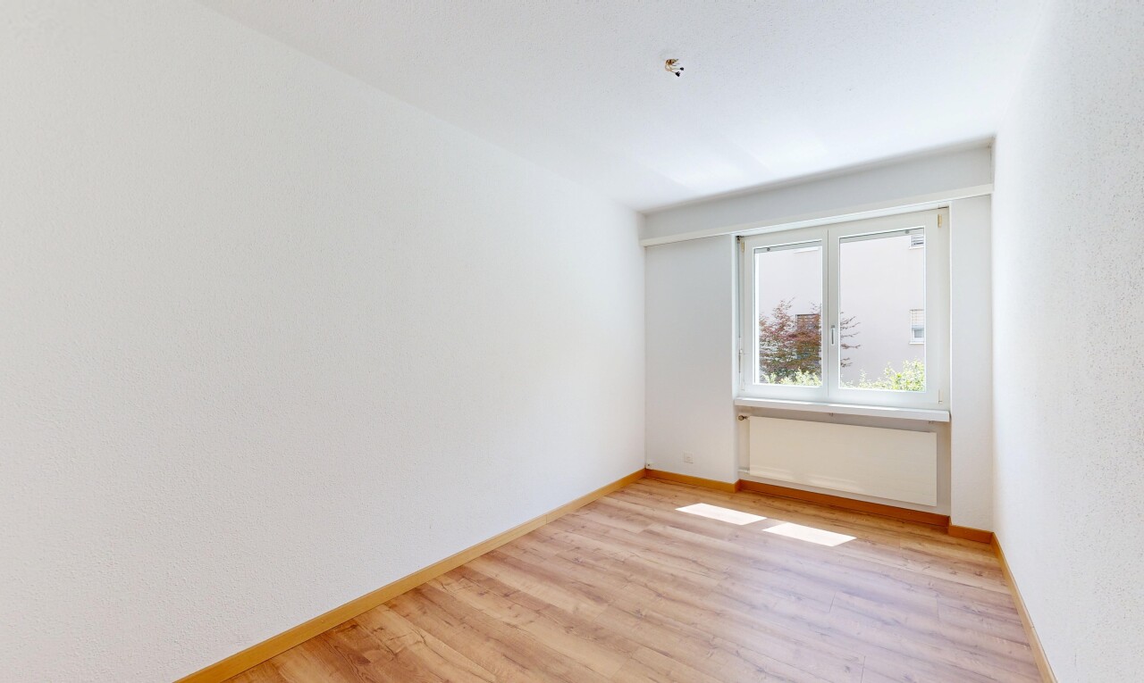 spare room with light wood-style floors and baseboards