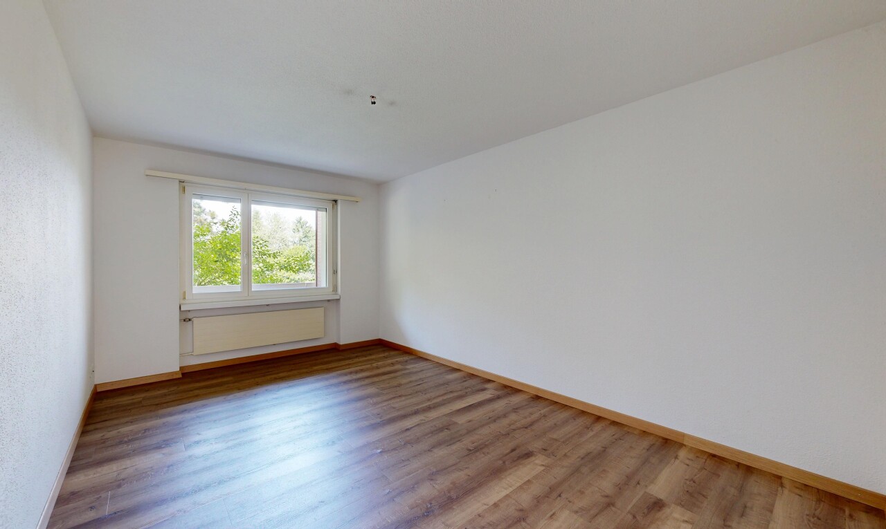 spare room featuring light wood-type flooring and baseboards
