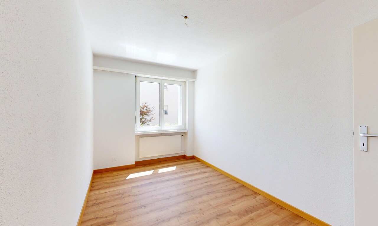 spare room with light wood-type flooring and baseboards