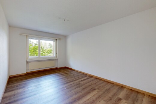 spare room featuring light wood-type flooring and baseboards