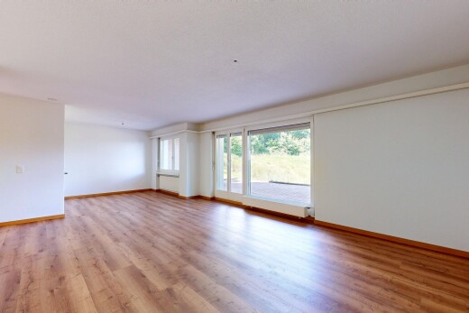 spare room featuring light wood-type flooring and baseboards