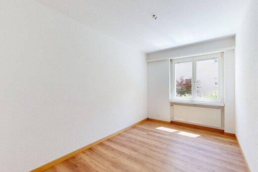 spare room with light wood-style floors and baseboards
