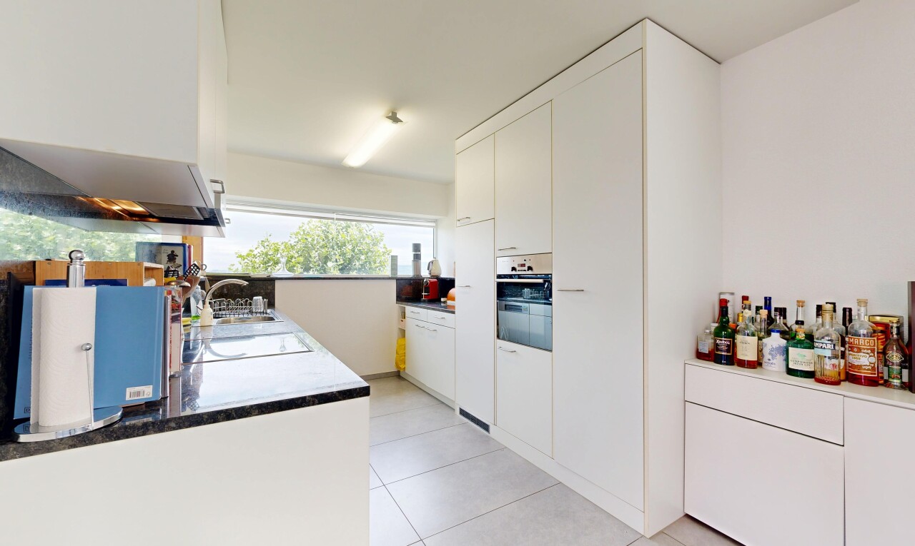 cuisine avec inside property, white cabinets, armoires blanches, light floor, et drywall