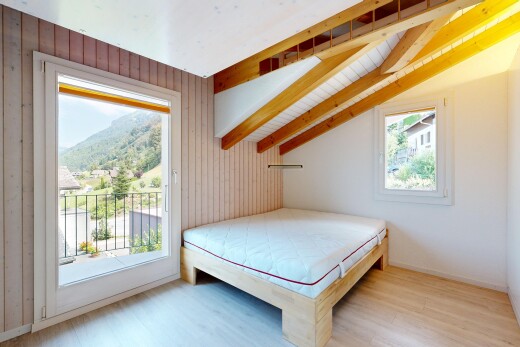 room with access to outside, lofted ceiling, wood walls, and light wood-style floors