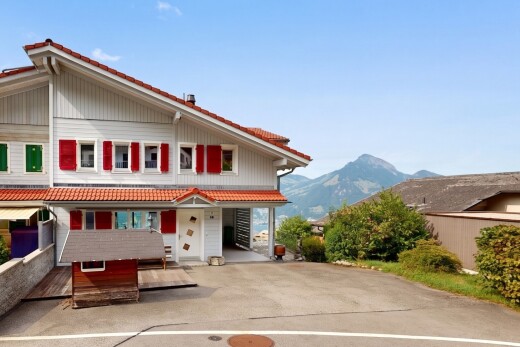 view of home with a tiled roof and a mountain view