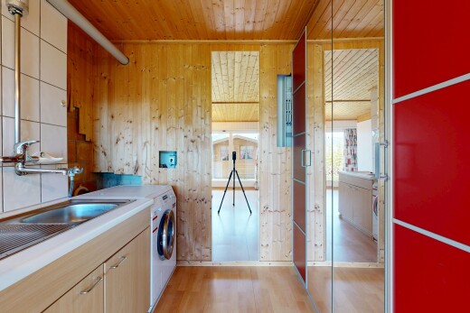 kitchen with wood walls, light wood finish cabinetry, light countertops, light wood-type flooring, and wooden ceiling