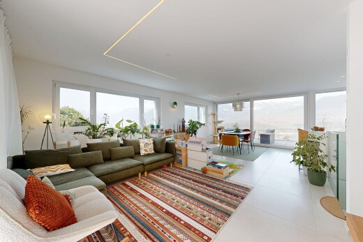 living area featuring healthy amount of natural light and light tile patterned floors