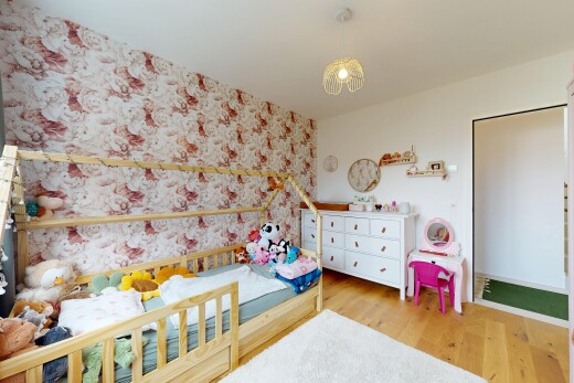 room with light wood-style floors and wallpapered walls