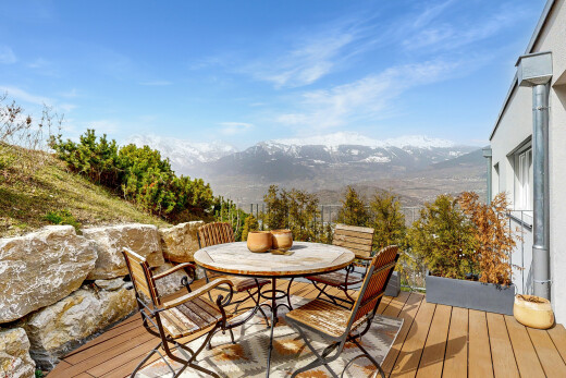 terrace featuring outdoor dining area and a deck with mountain view