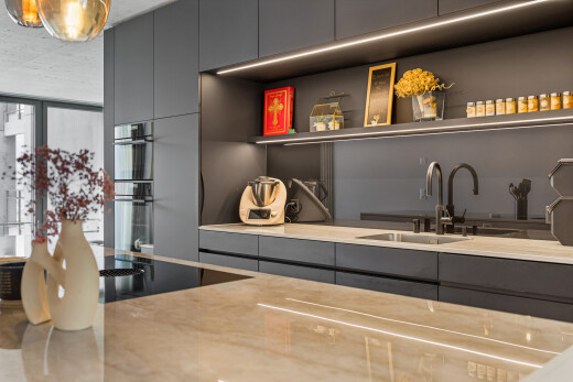 küche mit light countertops, schränke mit flachen paneelen, flat panel cabinets, waschbecken, und stein arbeitsplatten
