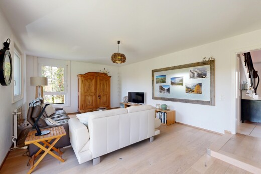 salon avec sol en finition bois, wood finish floor, télévision, inside property, et cloison sèche
