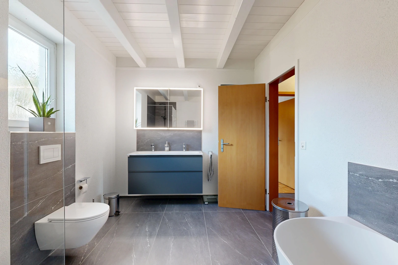 full bath featuring vanity, a tub, and beam ceiling