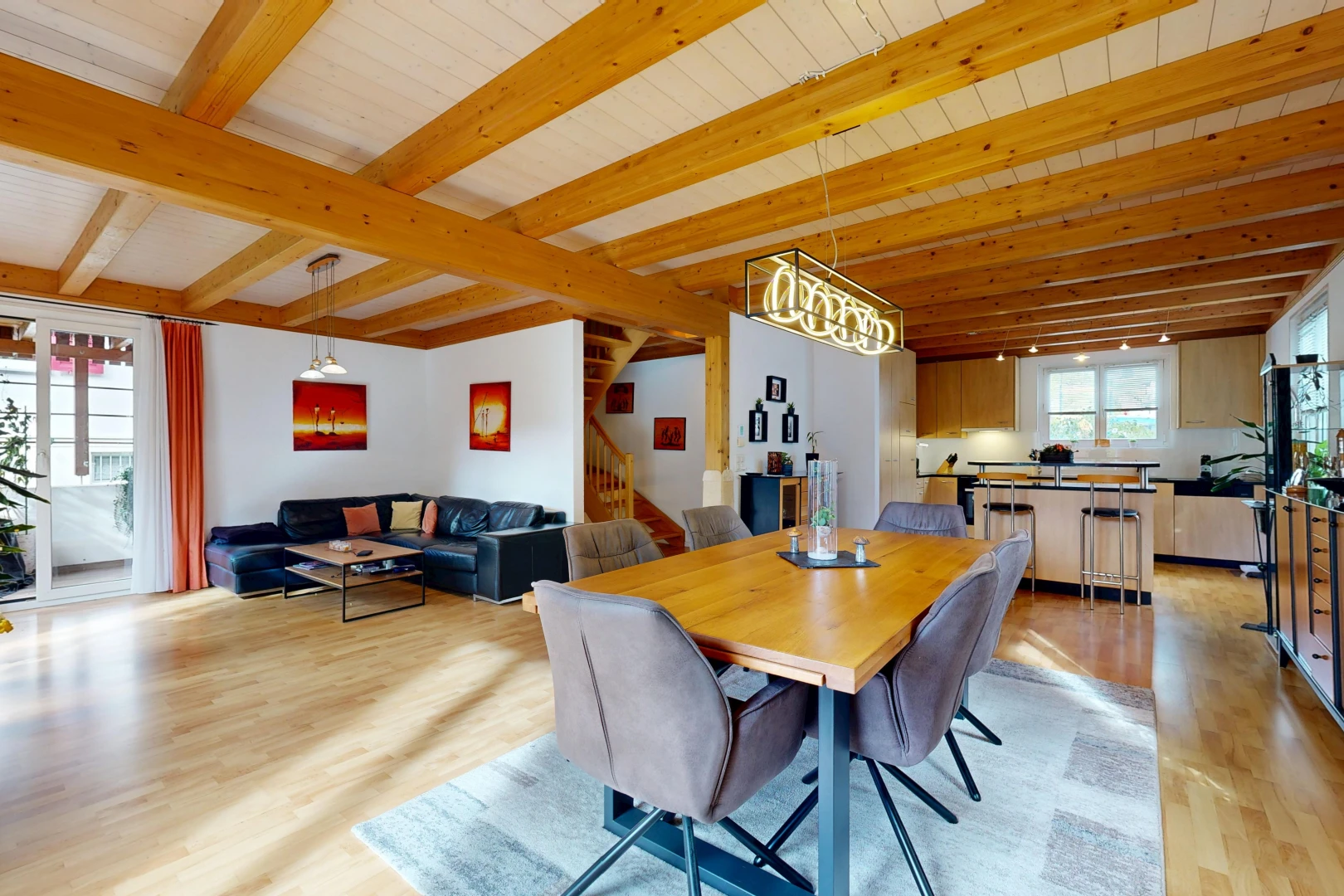 living / dining room with beamed ceiling, access to exterior, and light wood-style floors