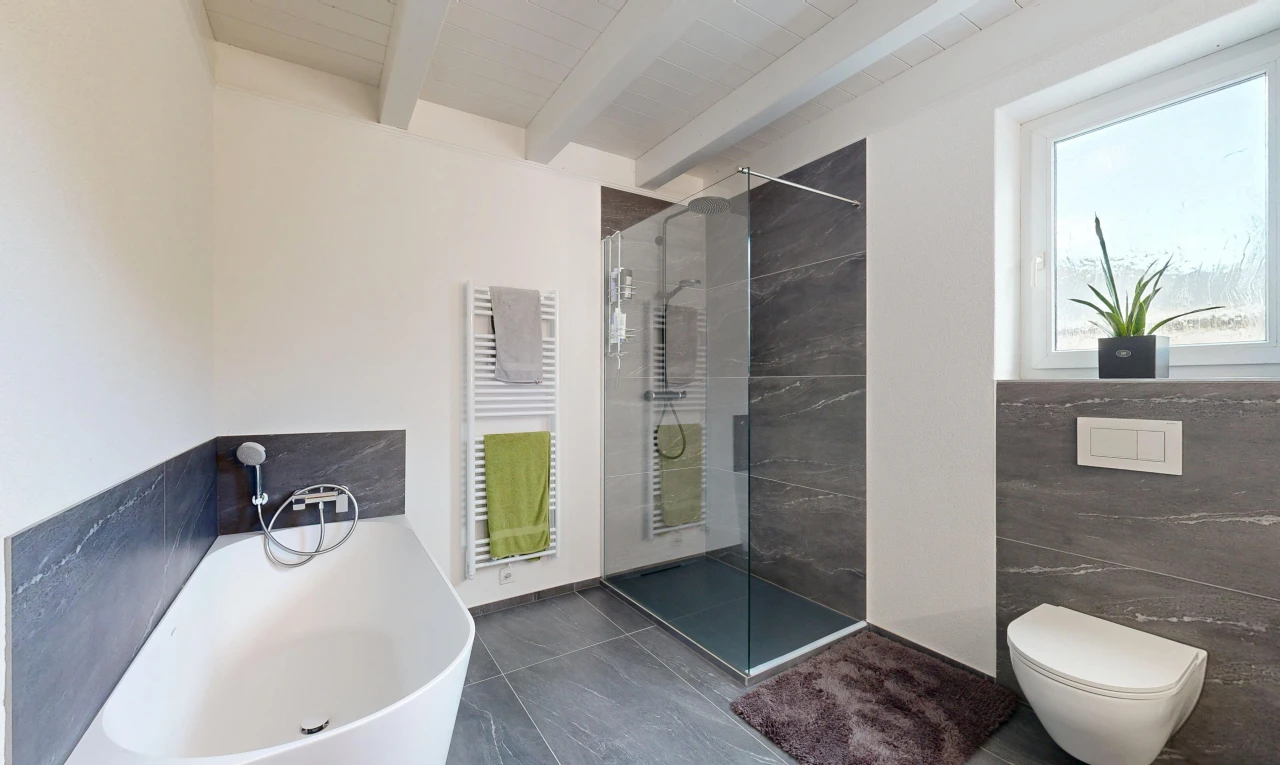 full bathroom featuring a towel warmer, radiator heating unit, a soaking tub, walk in shower, and beam ceiling