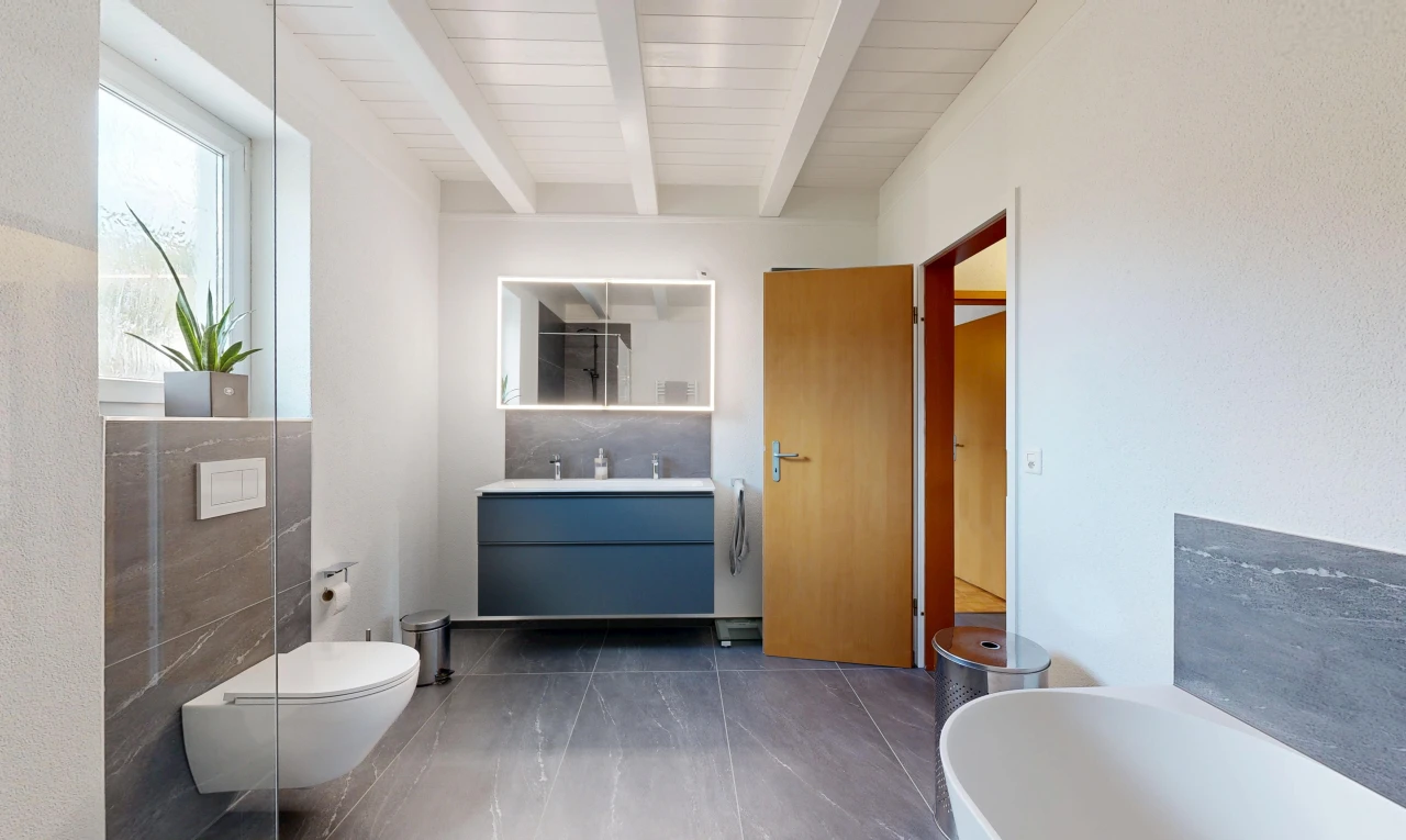 full bath featuring vanity, a tub, and beam ceiling