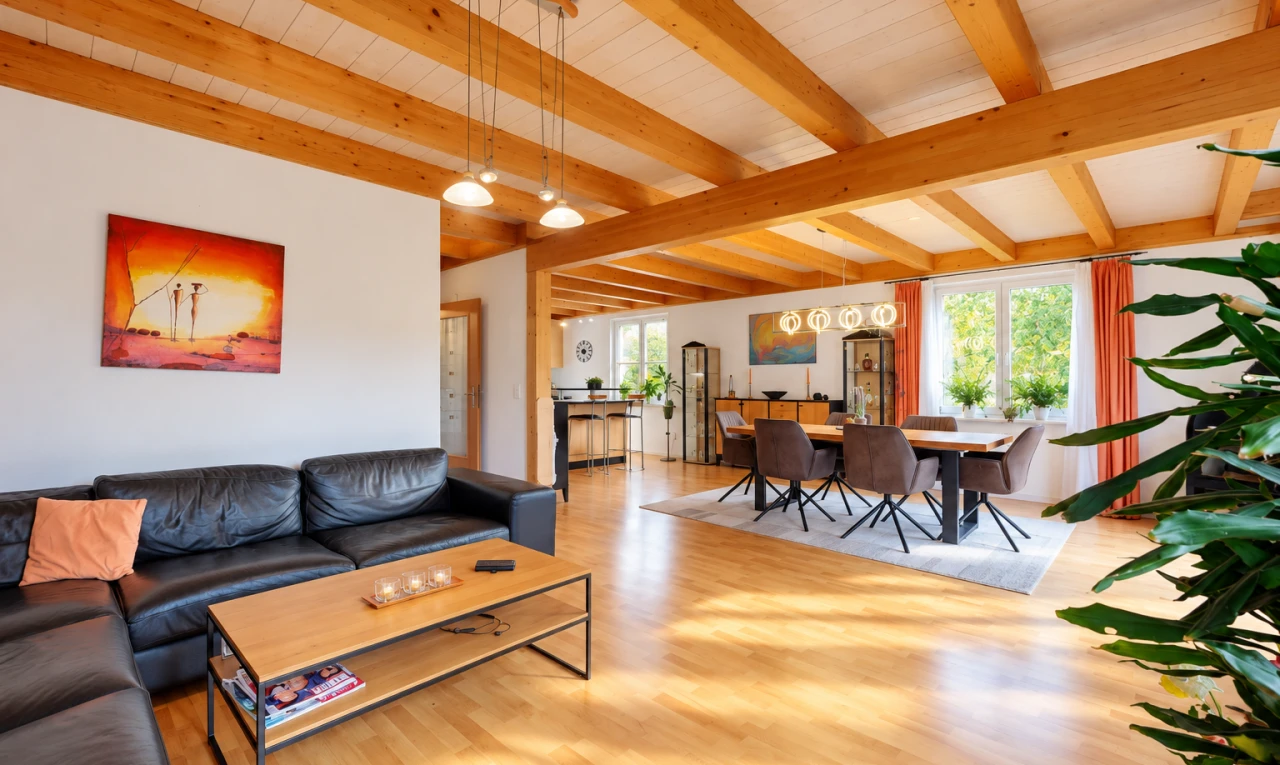 living area with beamed ceiling, pendant lighting, and light wood finished floors