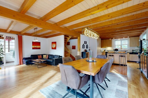 salon / salle à manger avec escaliers, beamed ceiling, plafond à poutres, inside property, et accès à l'extérieur