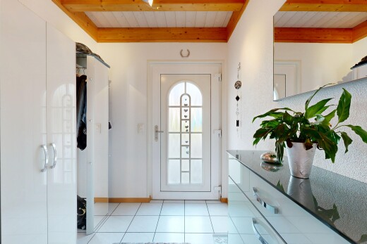 couloir avec light floor, accès à l'extérieur, tile floor, sol en carrelage, et drywall
