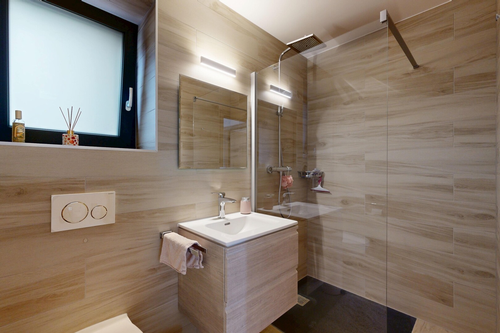 full bathroom with vanity, a walk in shower, and tile walls