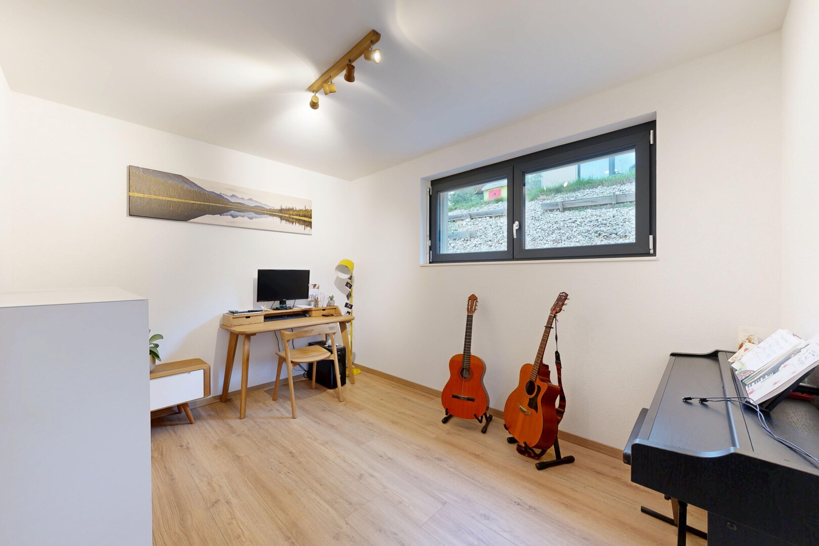 office space featuring light wood-style flooring and rail lighting